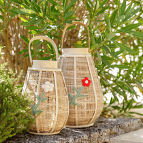 Des lanternes en toile de jute disposées sur un muret du jardin en décoration
