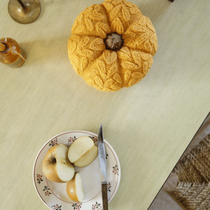 Une citrouille en tissu vue de haut avec une assiette contenant une pomme découpée