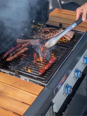 Un zoom sur la grille d'un homme en train de faire un barbecue